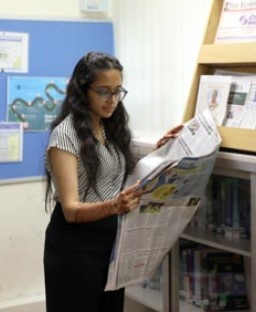 Student reading newspaper